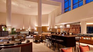 A spacious lobby with high ceilings, large windows, and a central bar area. - The Westin Rusutsu Resort (Rusutsu)
