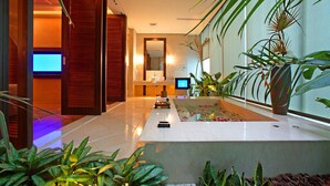A modern hotel lobby with a reception desk, a large mirror, and a water feature with plants. - Changhua KuiKuan Boutique Motel (Changhua)