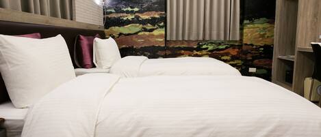 A hotel room with a large bed, a headboard, a wardrobe, and a mural on the wall.