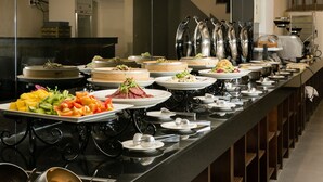 A buffet setup with various food items and serving dishes. - Yuhao Hotel Hsinchu (Hsinchu)