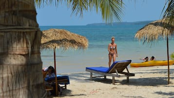 On the beach, sun-loungers, beach umbrellas, beach volleyball