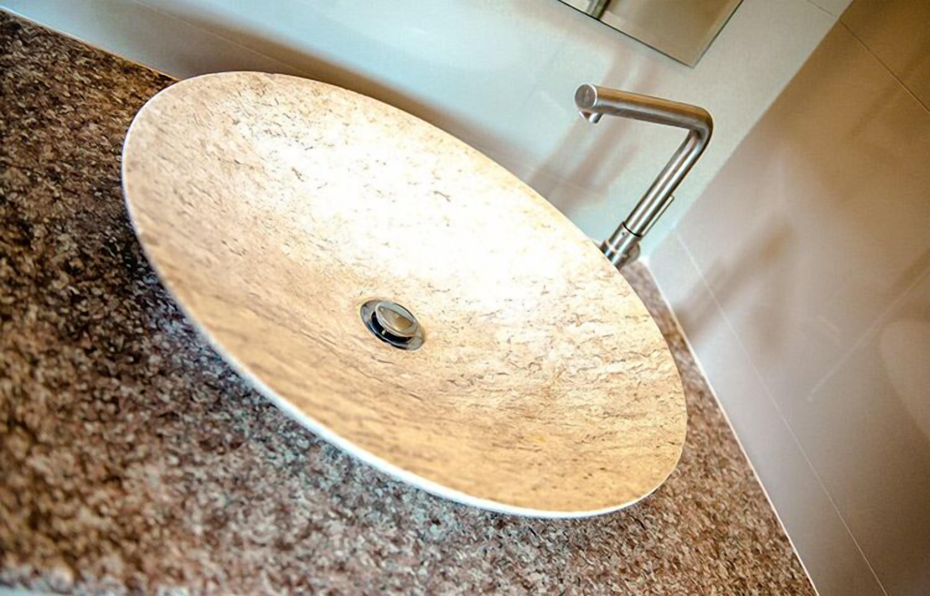 A bathroom sink with a wooden basin and a modern faucet.
