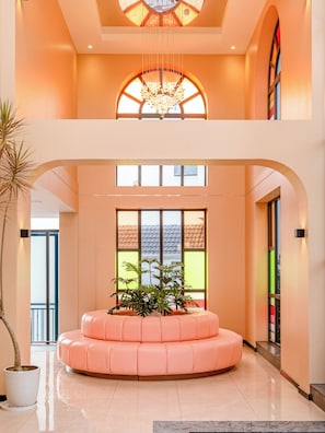 A spacious lobby with a central seating area, large windows, and a decorative chandelier. - Hong Mon Resort Da Lat (Xuan Huong - Da Lat)
