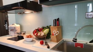 A modern kitchen with a built-in stove, a sink, and a variety of kitchen utensils and appliances. - Hong Mon Resort Da Lat (Xuan Huong - Da Lat)