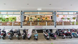 A storefront with a sign reading "Situs Court" and a row of parked scooters in front. - Sutus Court 3 (Pattaya)
