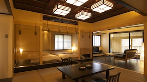 A traditional Japanese-style room with tatami flooring, a low table, and a futon bed.