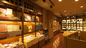 A bookstore with wooden shelves and a variety of books and boxes.
