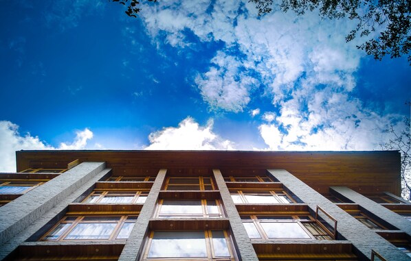 A building with a wooden facade and multiple windows.