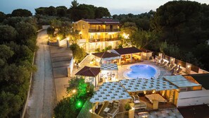 A villa with a swimming pool, outdoor seating, and a stone pathway. - Skiathos Island Suites (Skiathos)