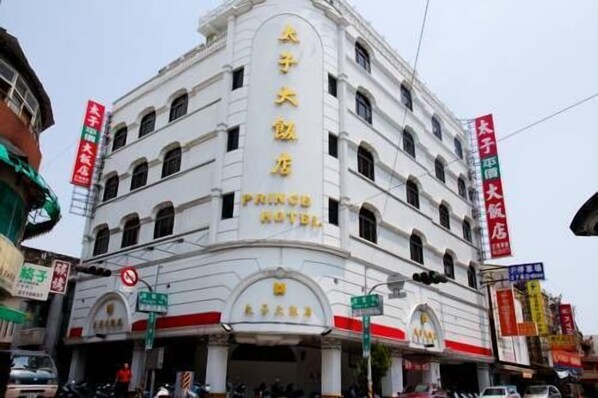 A multi-story building with a sign reading "Prince Hotel".