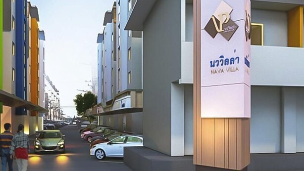Un edificio moderno con un letrero que dice 'NAVA VILLA'.
