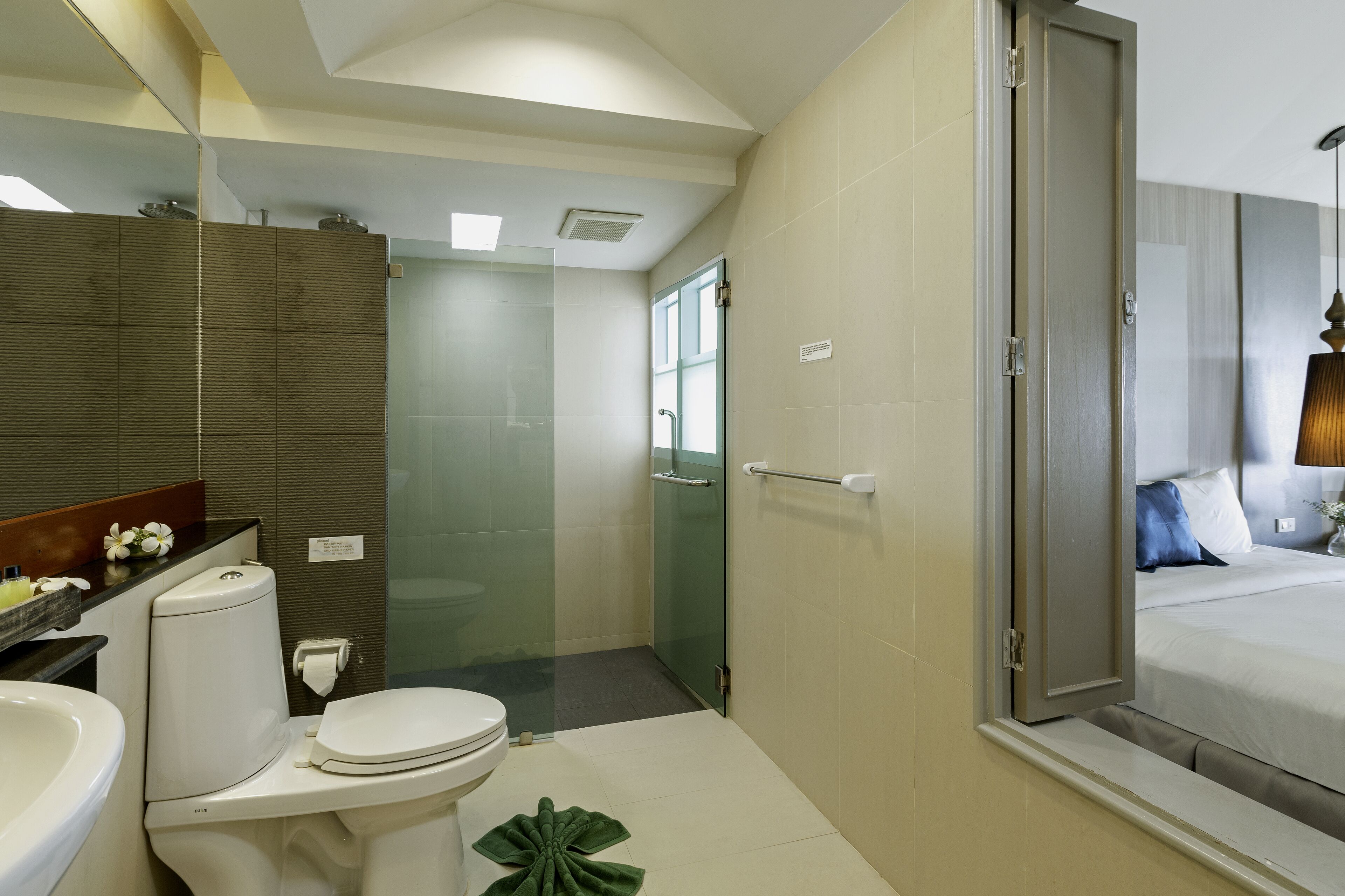 A modern bathroom with a toilet, sink, and shower area.