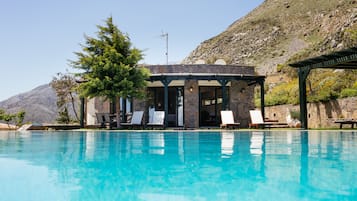 Seasonal outdoor pool, an infinity pool, pool umbrellas, pool loungers
