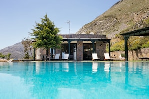 Seasonal outdoor pool, an infinity pool, pool umbrellas, sun loungers