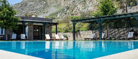 Seasonal outdoor pool, an infinity pool, pool umbrellas, pool loungers