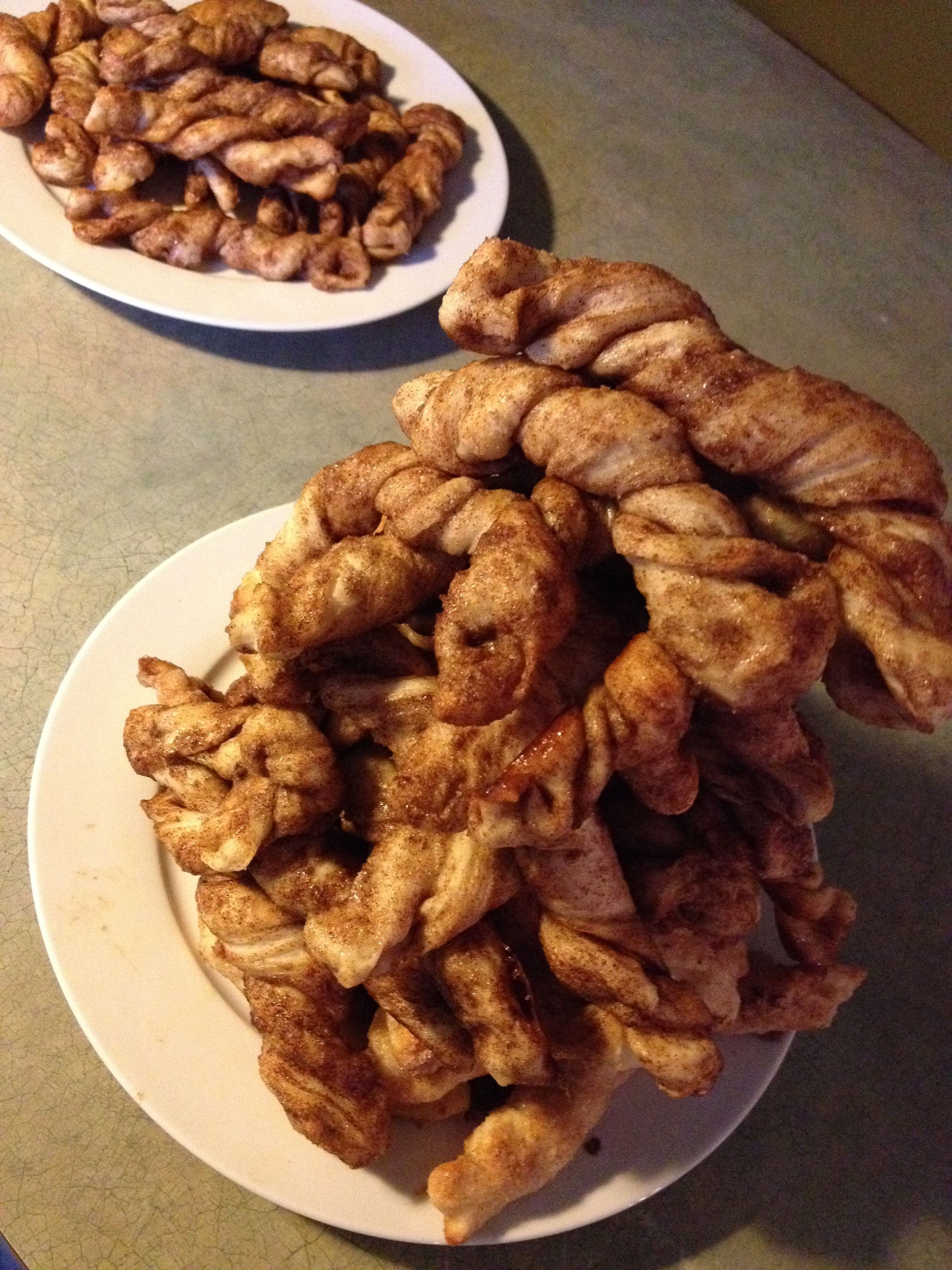Two plates of fried chicken wings on a table.