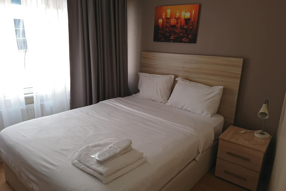 Premium bedding, blackout curtains, iron/ironing board (on request)