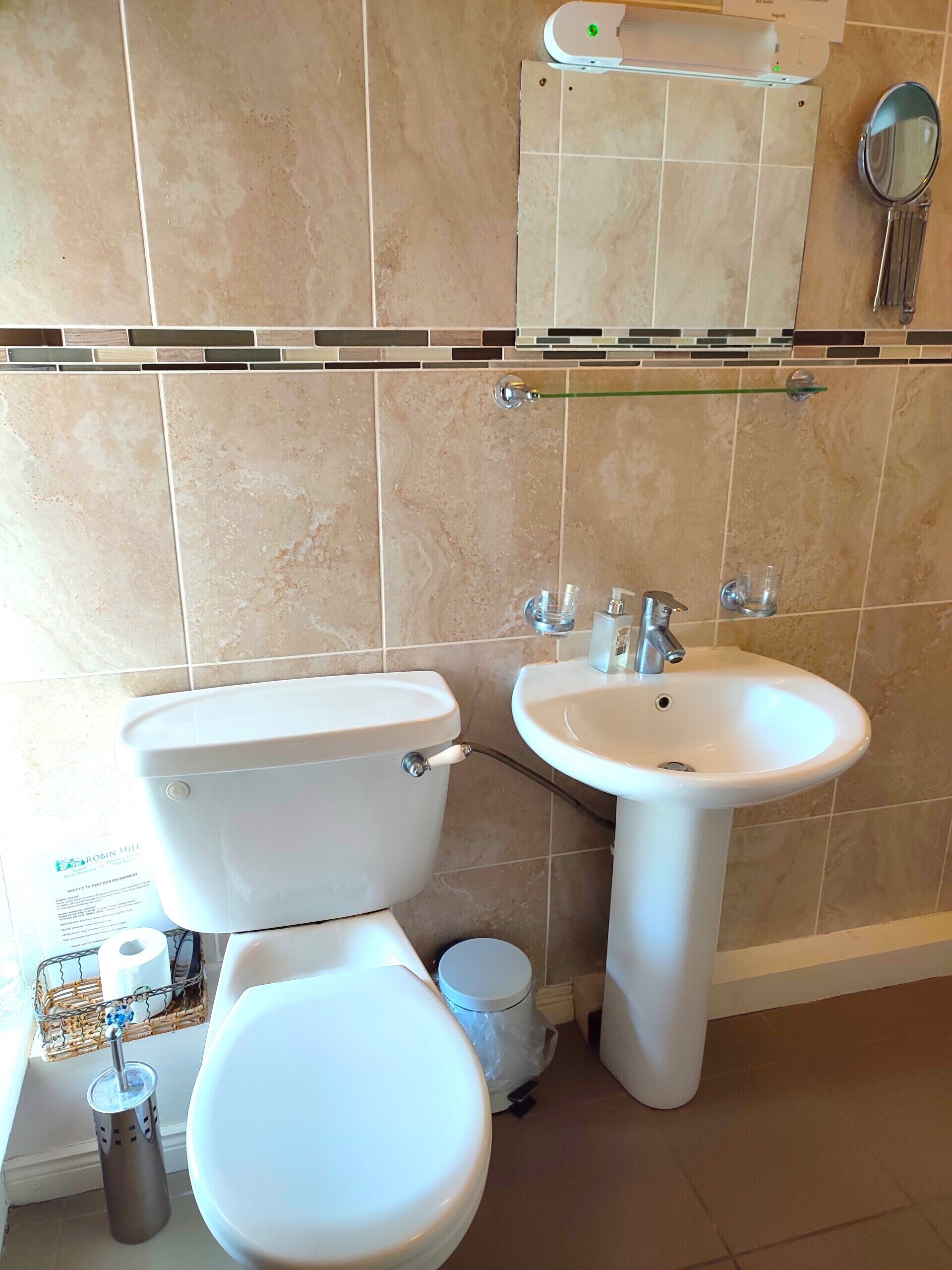 A bathroom with a toilet, bidet, and sink.