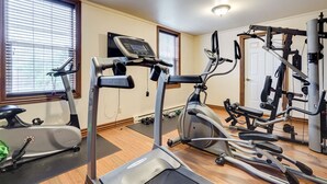 A home gym with treadmills, elliptical machines, and weight equipment. - Le Grand Hôtel (Baie Comeau)