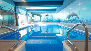 Enjoy a refreshing swim in our pool, surrounded by a vibrant marine life mural and equipped with handrails for added safety.