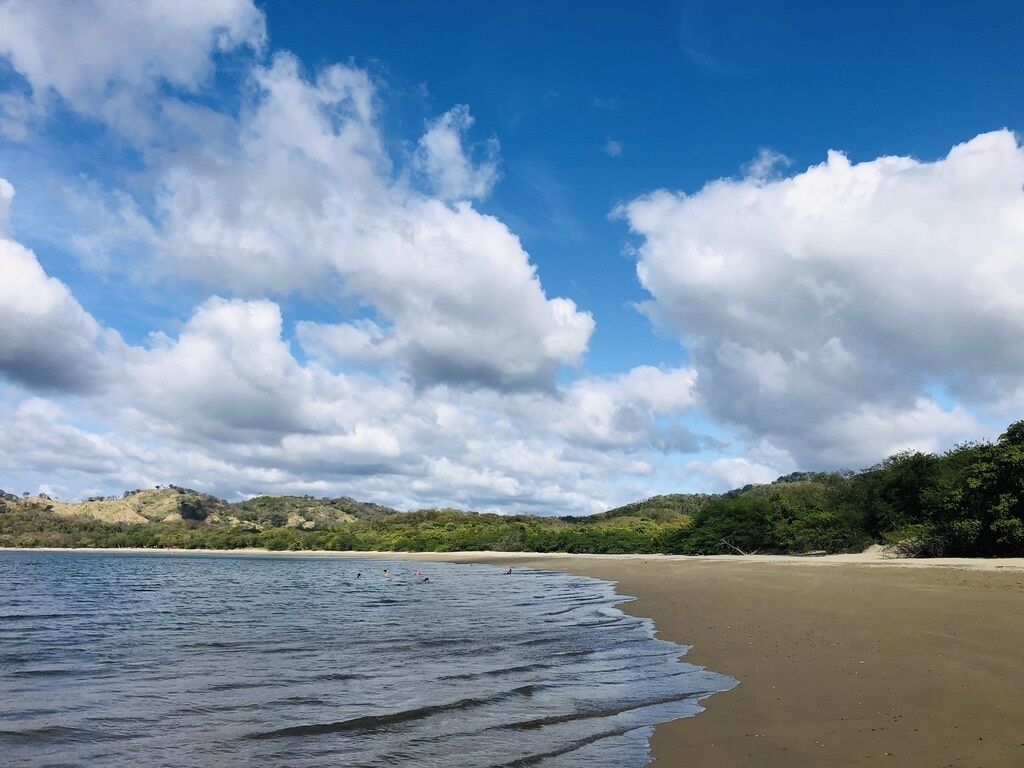 A beach with clear skies and gentle waves.