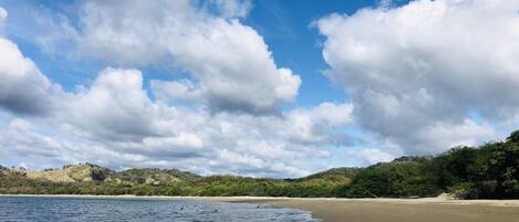 A beach with clear skies and gentle waves.