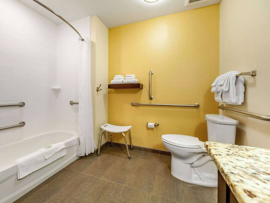 A bathroom with a bathtub, toilet, and sink.