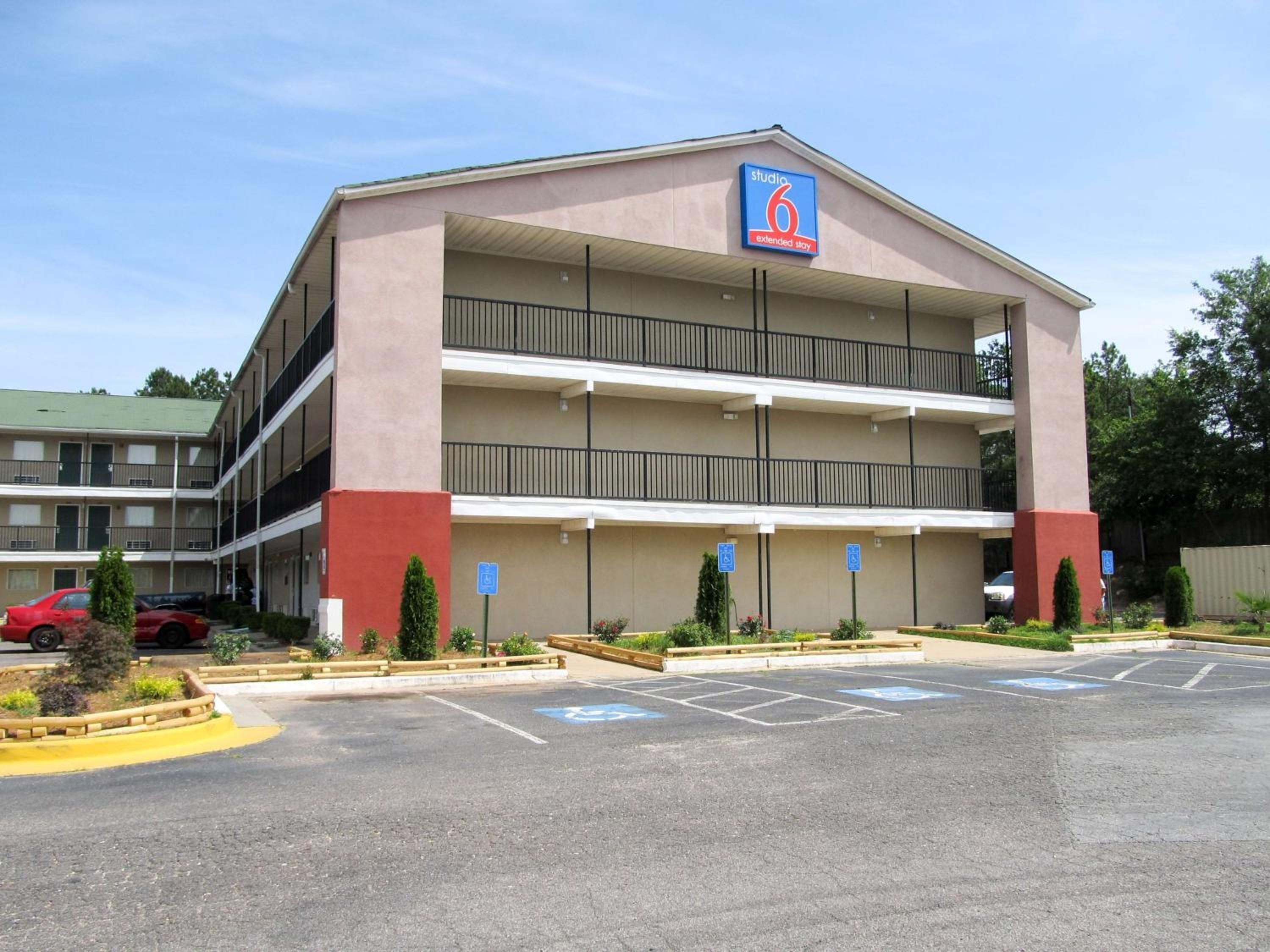 A multi-story motel with a parking lot and handicap-accessible parking spaces.