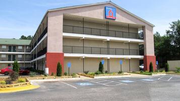 A multi-story motel with a parking lot and handicap-accessible parking spaces.