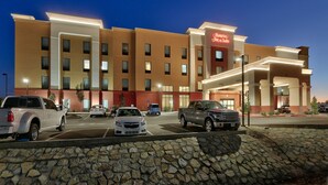 A hotel with a modern facade, multiple parking spaces, and a well-lit entrance. - Hampton Inn & Suites Las Cruces I-10 (Las Cruces)