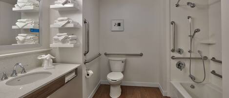 A modern bathroom with a sink, toilet, and shower.