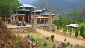 A two-story house with a stone foundation, multiple rooms, and a covered porch. - Taktsang Boutique Resort & Spa (Paro)