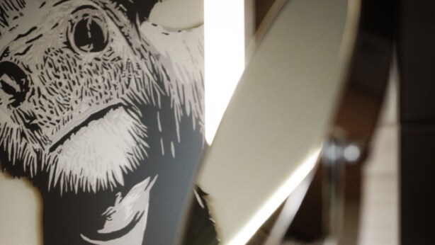 A bathroom with a mirror, a wooden cabinet, and a wall-mounted artwork of a dog.