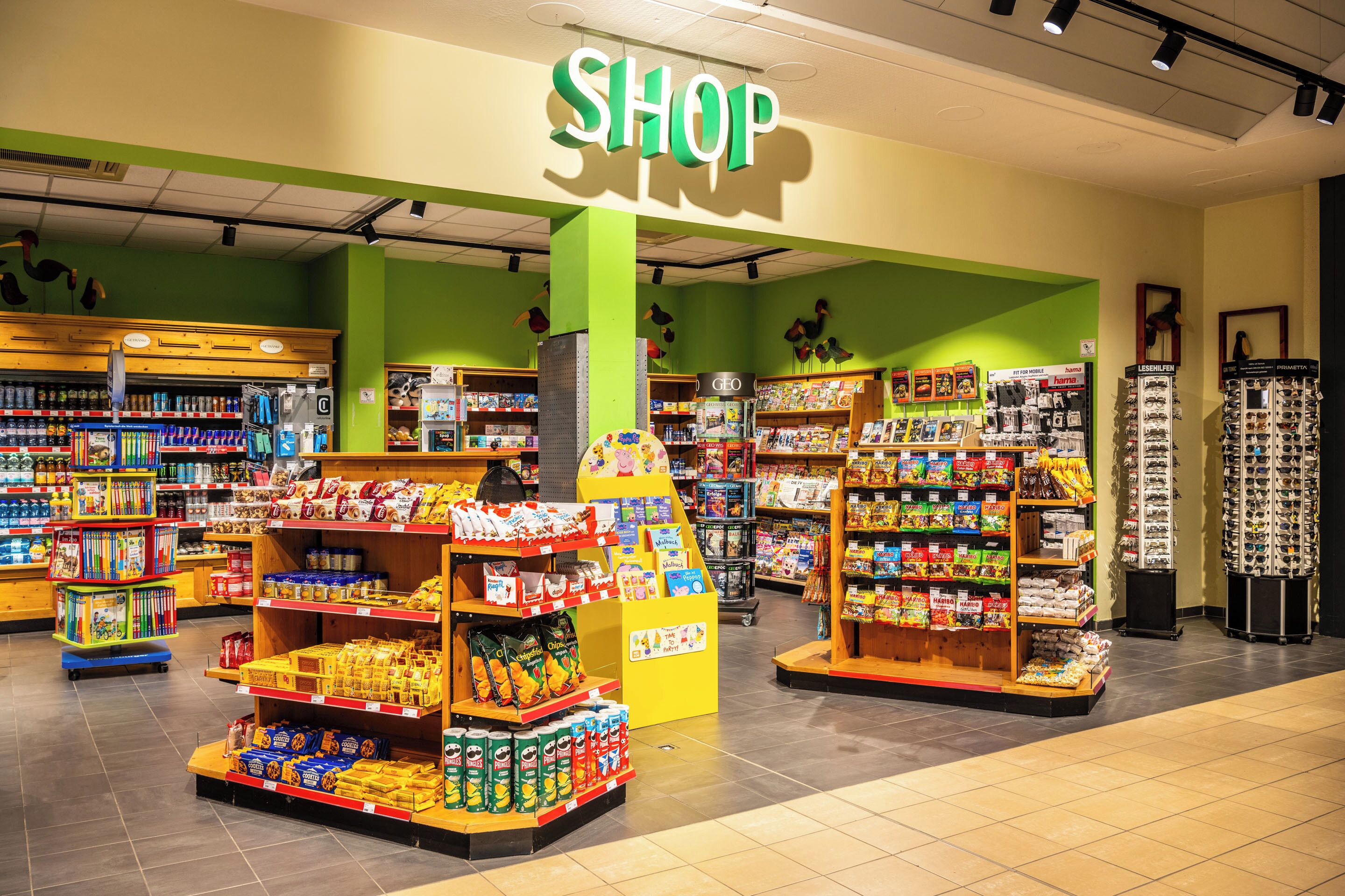A brightly lit grocery store with various aisles and shelves stocked with products.