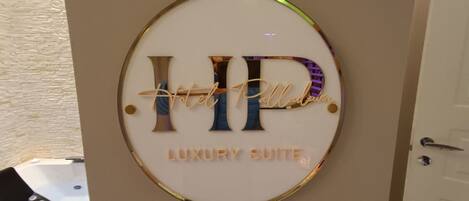 A sign with the letters "HP" and the words "Luxury Suite" indicating a high-end accommodation area.