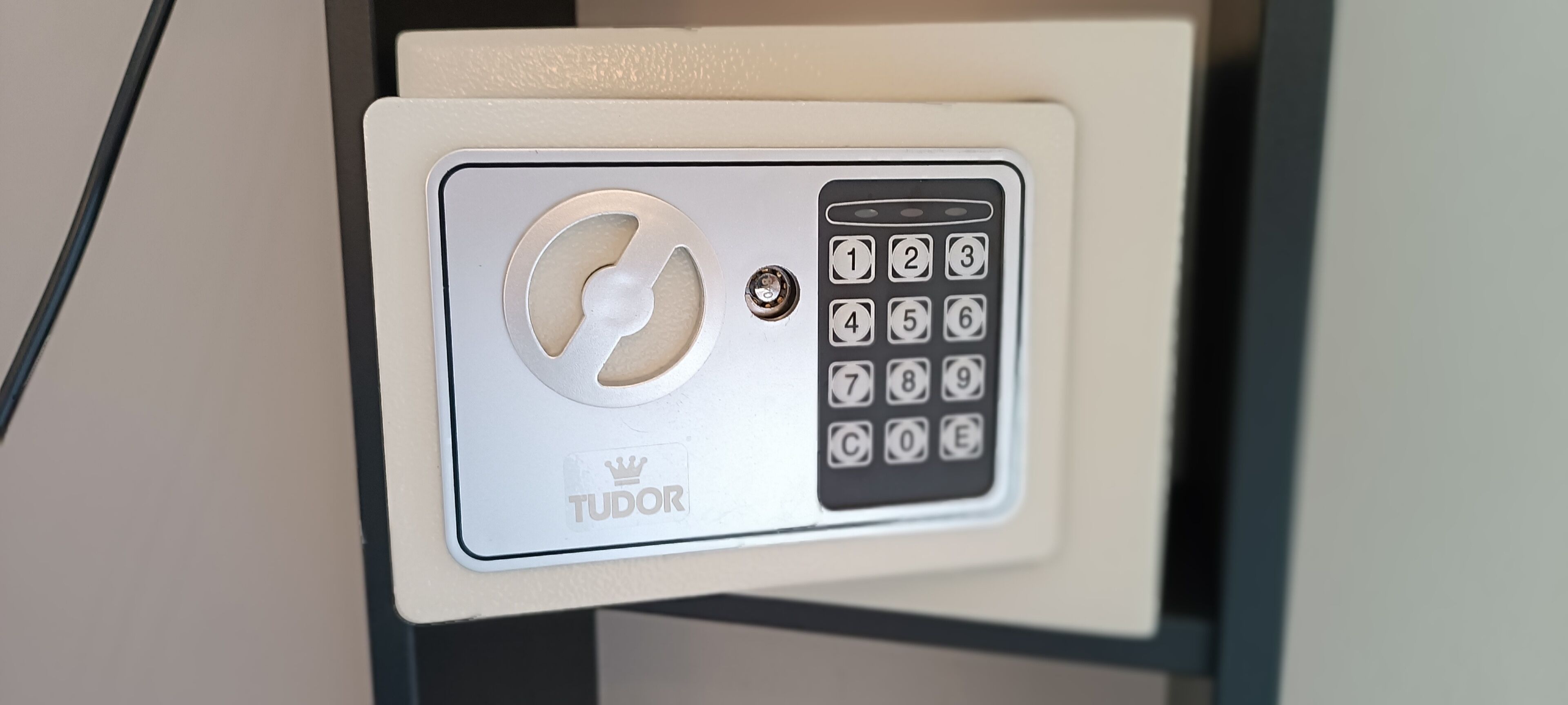 A keypad lock with a Tudor logo, a keyhole, and a numeric keypad.