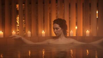 Relax in a serene space with a bathtub and candles.
