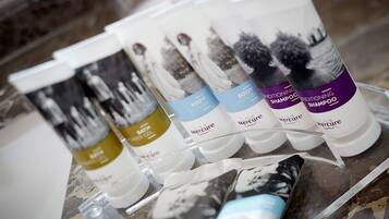 A display of Mercure hotel toiletries including body lotion, shampoo, and conditioner.