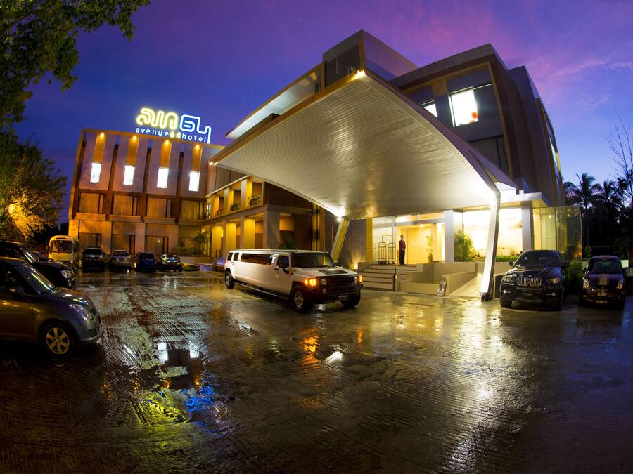A hotel with a modern design, featuring a covered entrance and multiple floors.