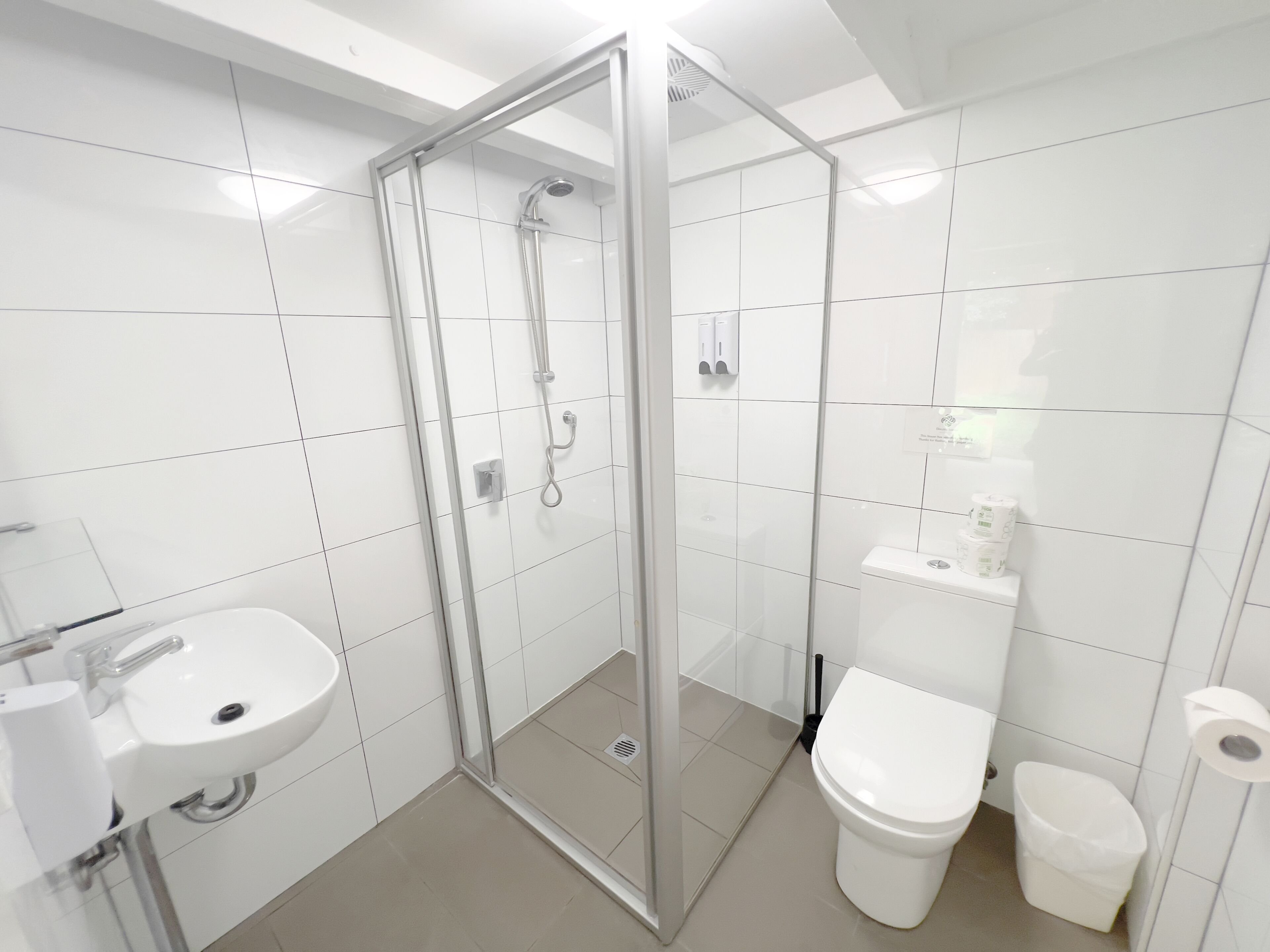 city studio suite, private bathroom, courtyard area | bathroom | shower, hair dryer, towels