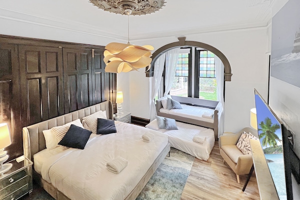 Heritage Family Room Shared Bathroom | Desk, laptop workspace, blackout drapes, iron/ironing board