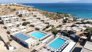 A resort with multiple buildings, a central swimming pool, and a view of the sea. - Ariadne Beach - Adults Only (Agios Nikolaos)