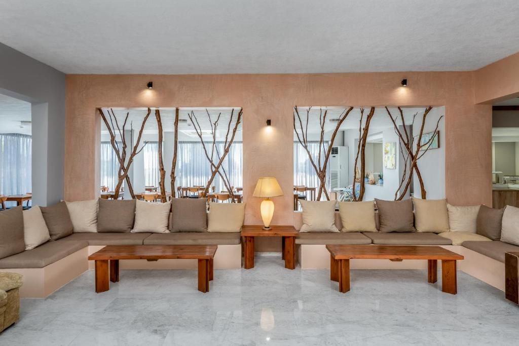 A modern living room with a sectional sofa, two wooden coffee tables, and a lamp.