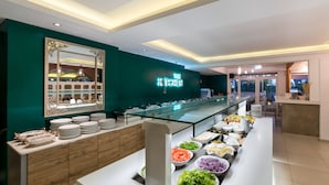 A buffet setup with various food items and a neon sign reading "The Kitchen". - Hotel Sirocco - Adults Only (Zakynthos)