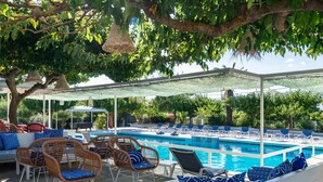 A pool area with lounge chairs and a seating area. - Hotel Sirocco - Adults Only (Zakynthos)