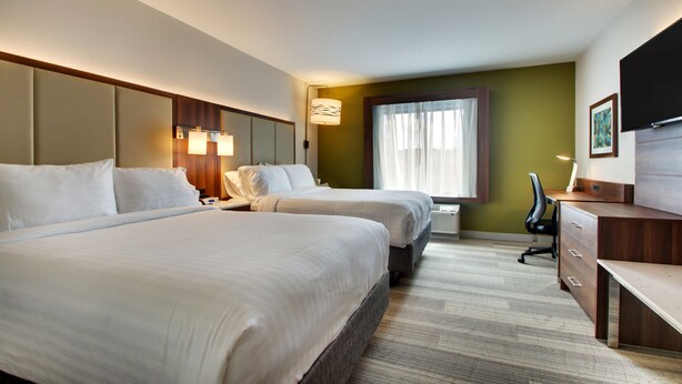 A hotel room with two beds, a desk, a chair, a TV, and a window with curtains. - Holiday Inn Express Helen by IHG (Helen)