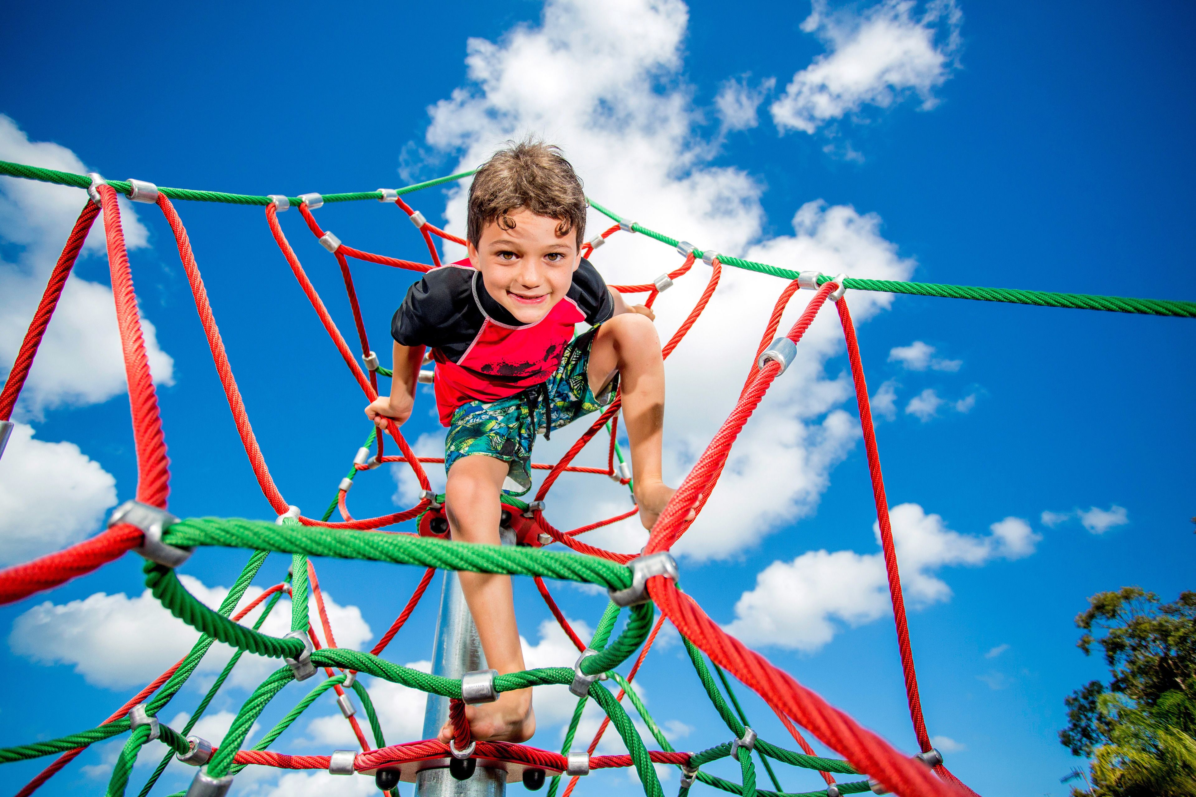 A child climbing a rope structure.