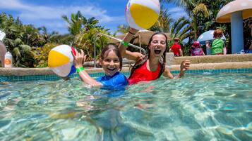 Guests can enjoy a refreshing swim in the pool surrounded by lush tropical vegetation.