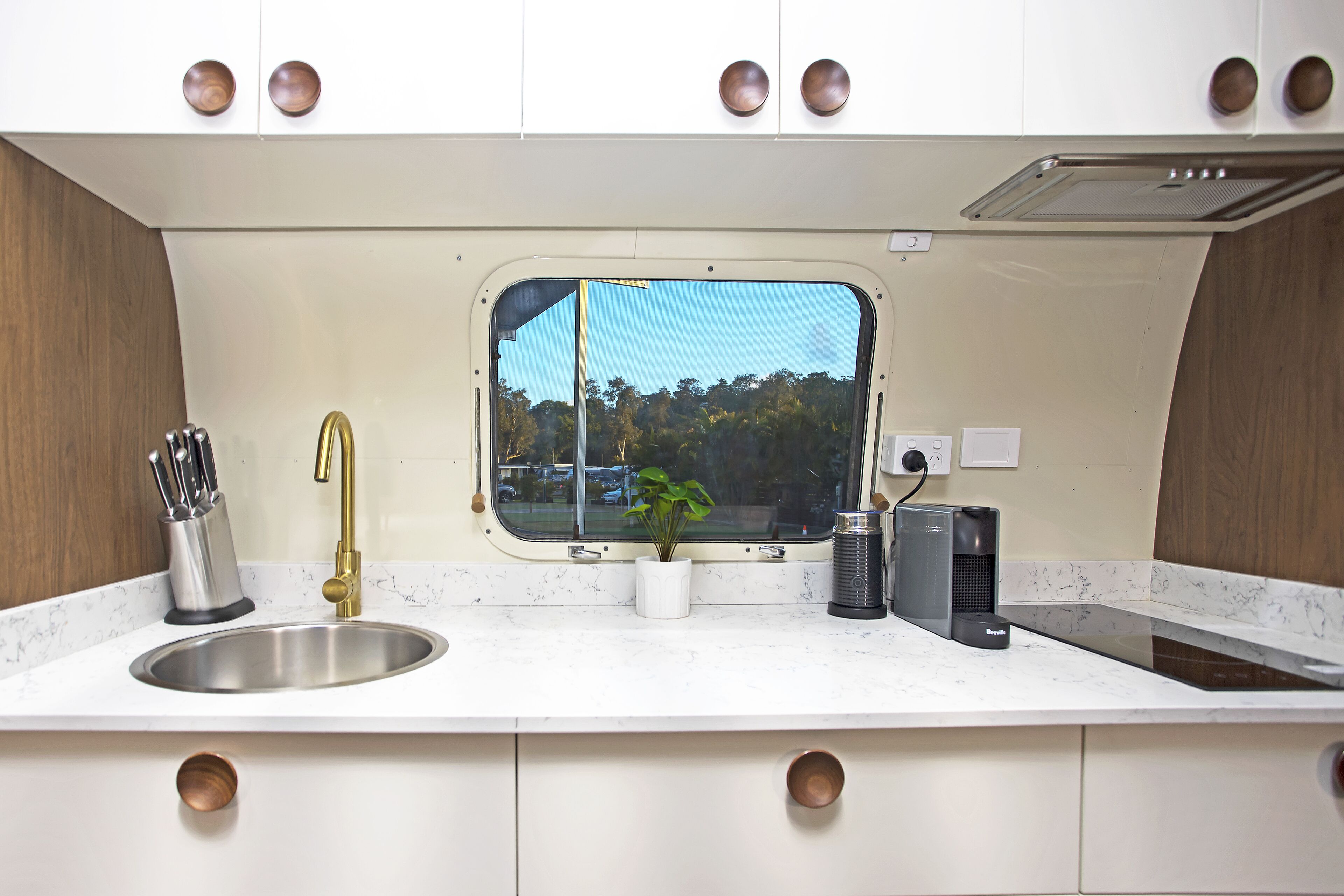 Una cocina con pileta, grifo, ventana y encimera.