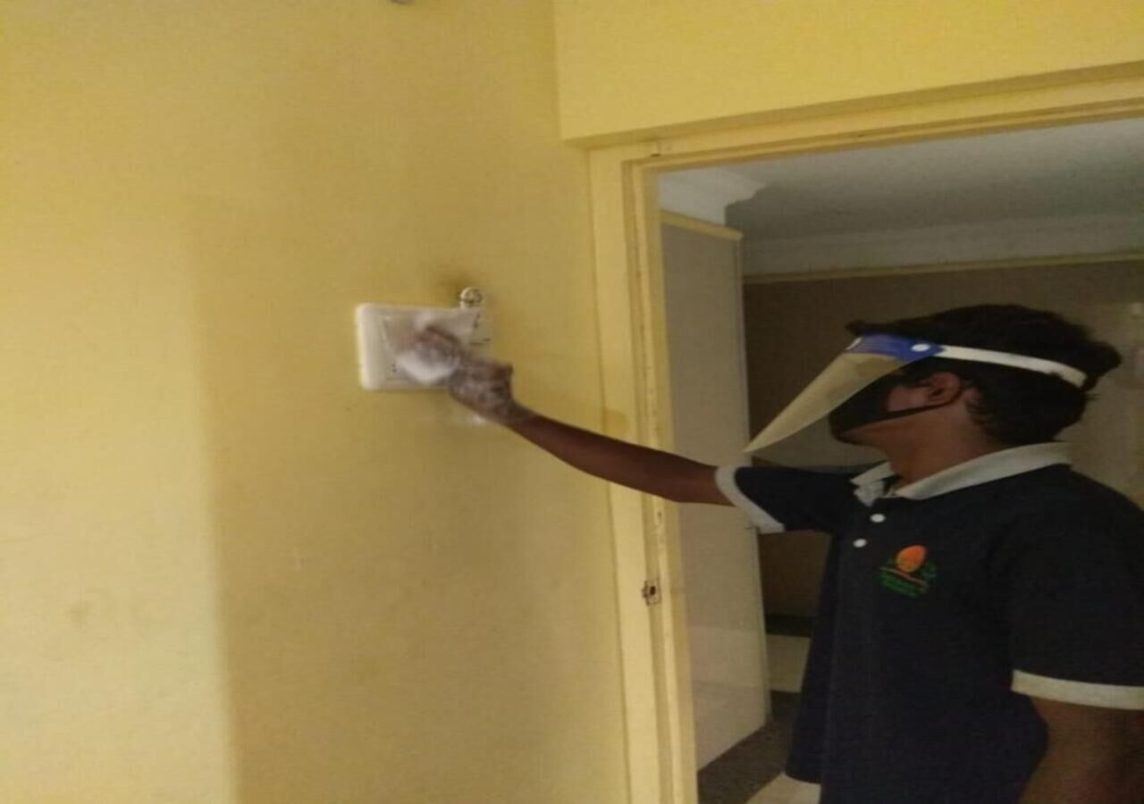A person painting a yellow door.